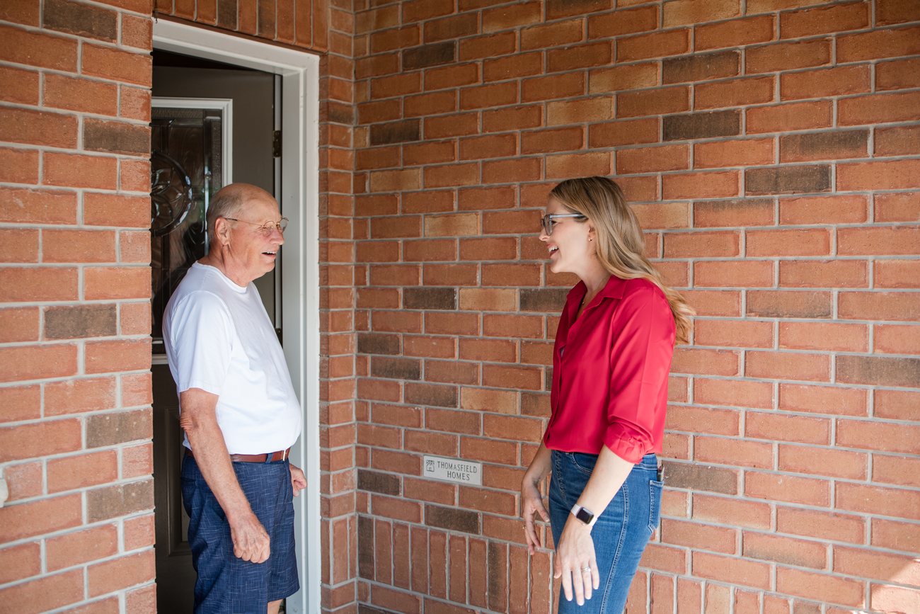 Eryn Koncir speaking with a Ward 3 resident on their doorstep